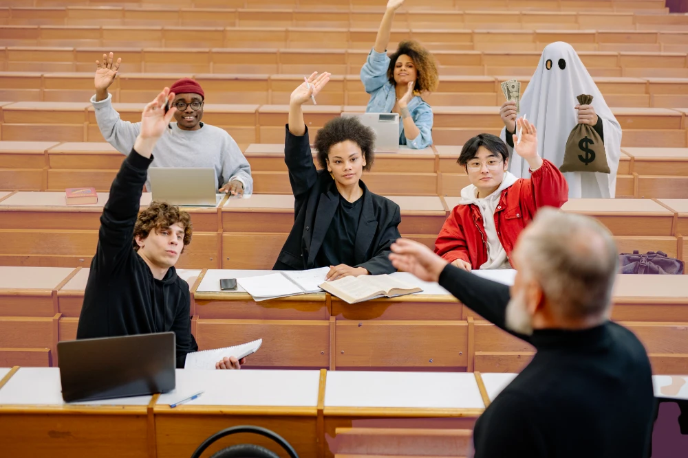 Students raising hands in a lecture hall with a ghost holding a money bag, symbolising financial aid fraud in colleges.
